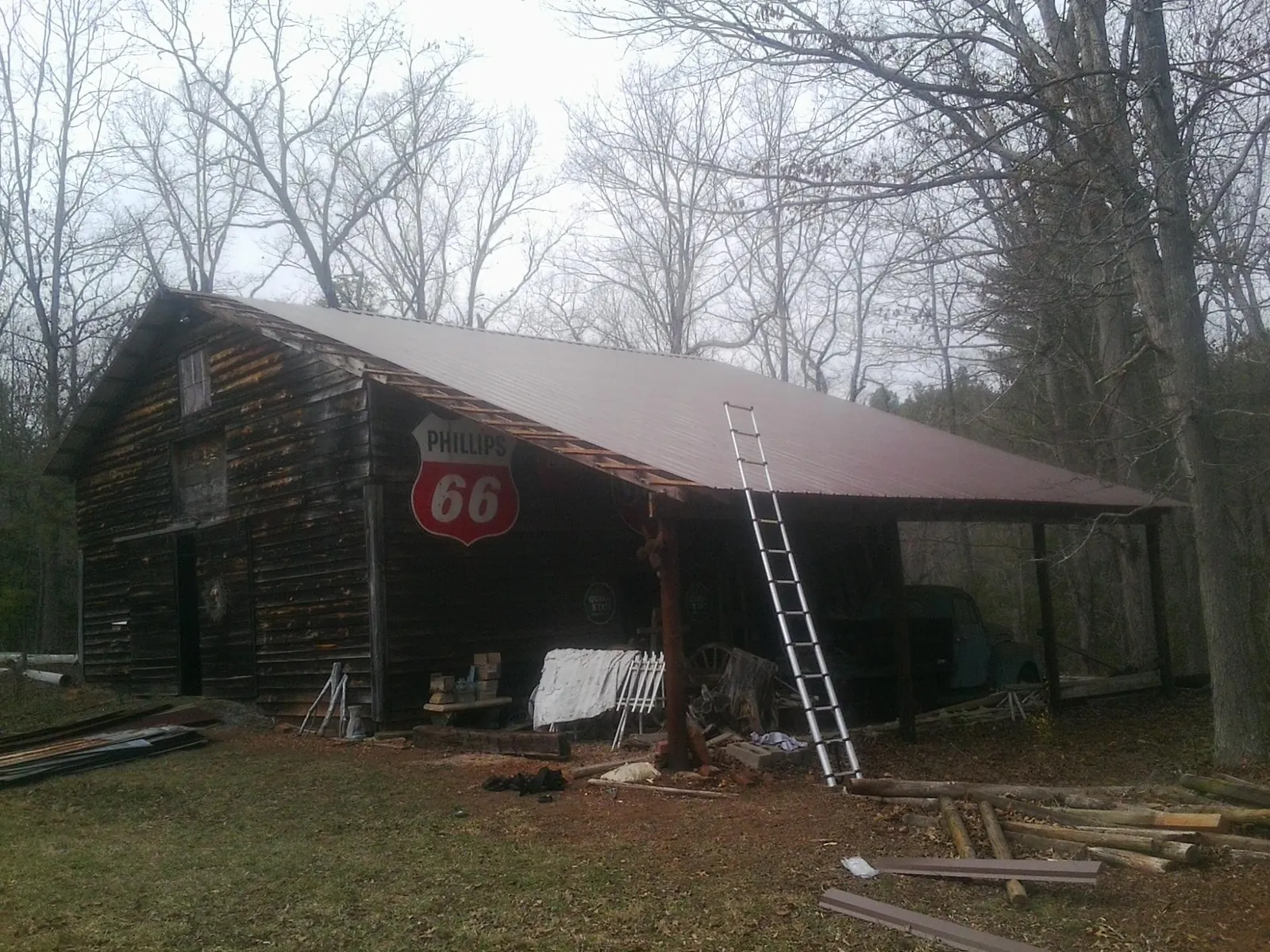 New metal roof on an open sided timber barn with a vintage sign in Taneytown