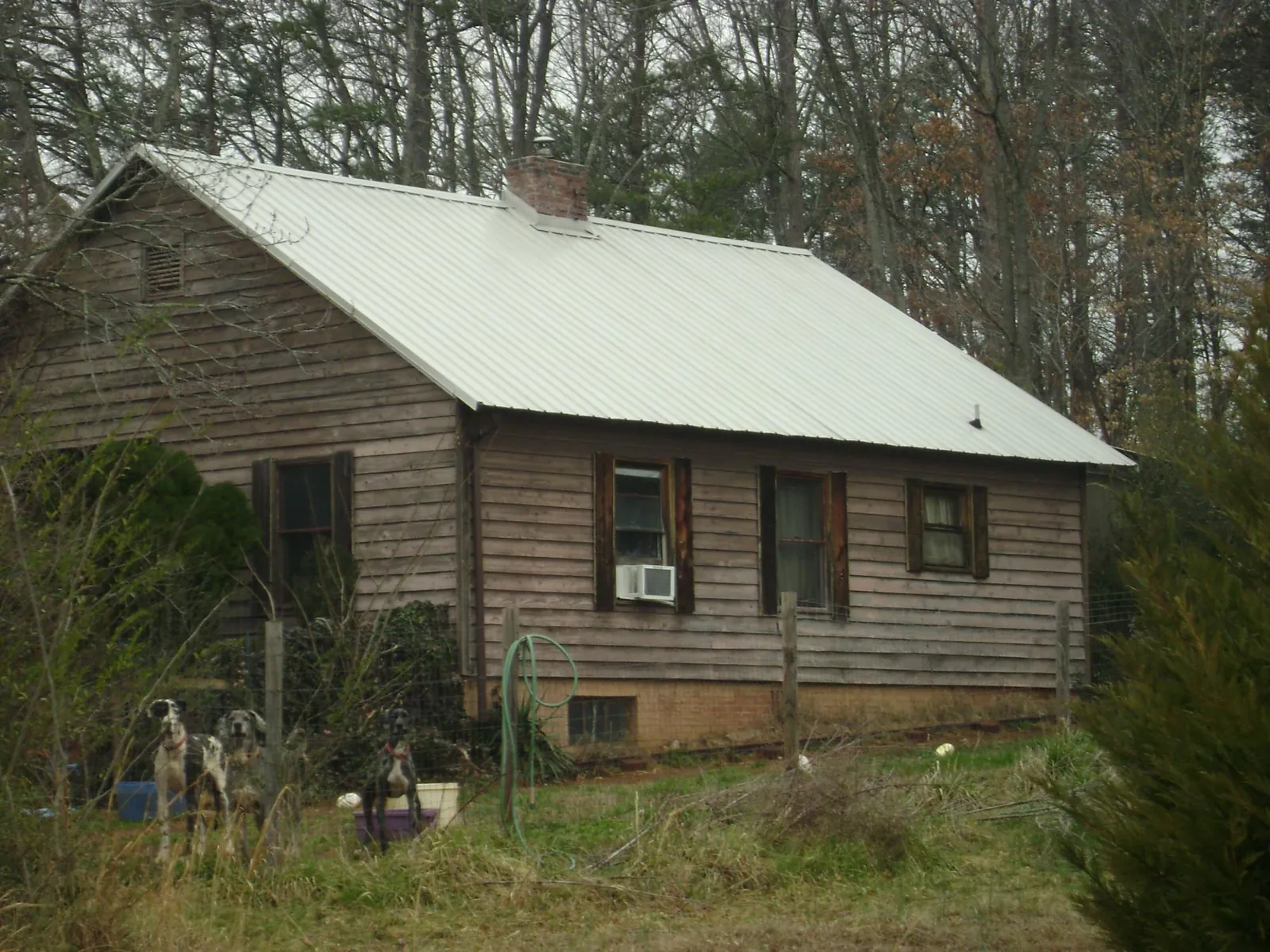 White metal roof on an old wood sided farmhouse, from a Metal Roof Installation job in Taneytown